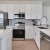 a kitchen with white cabinets