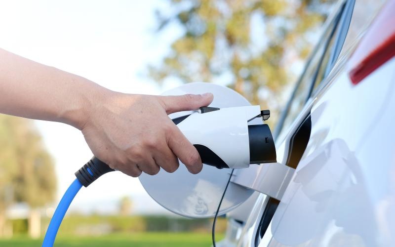 a person charging a car